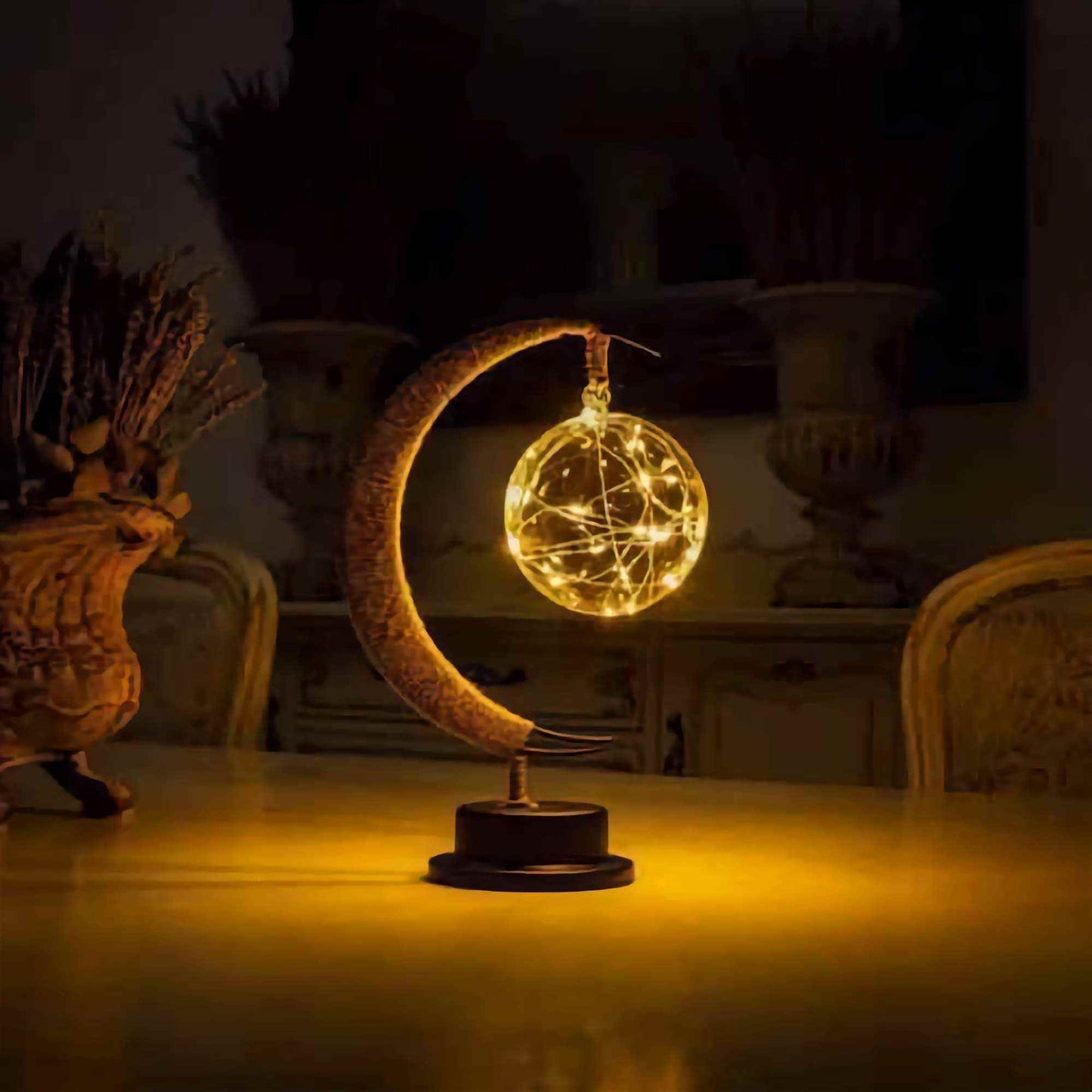 Enchanted Lunar LampThe lamp's versatile design functions as both a book light and atmospheric enhancer. Featuring a crescent-shaped lamp holder, a glass globe lampshade, and a black ir1724Enchanted Lunar Lamplighting